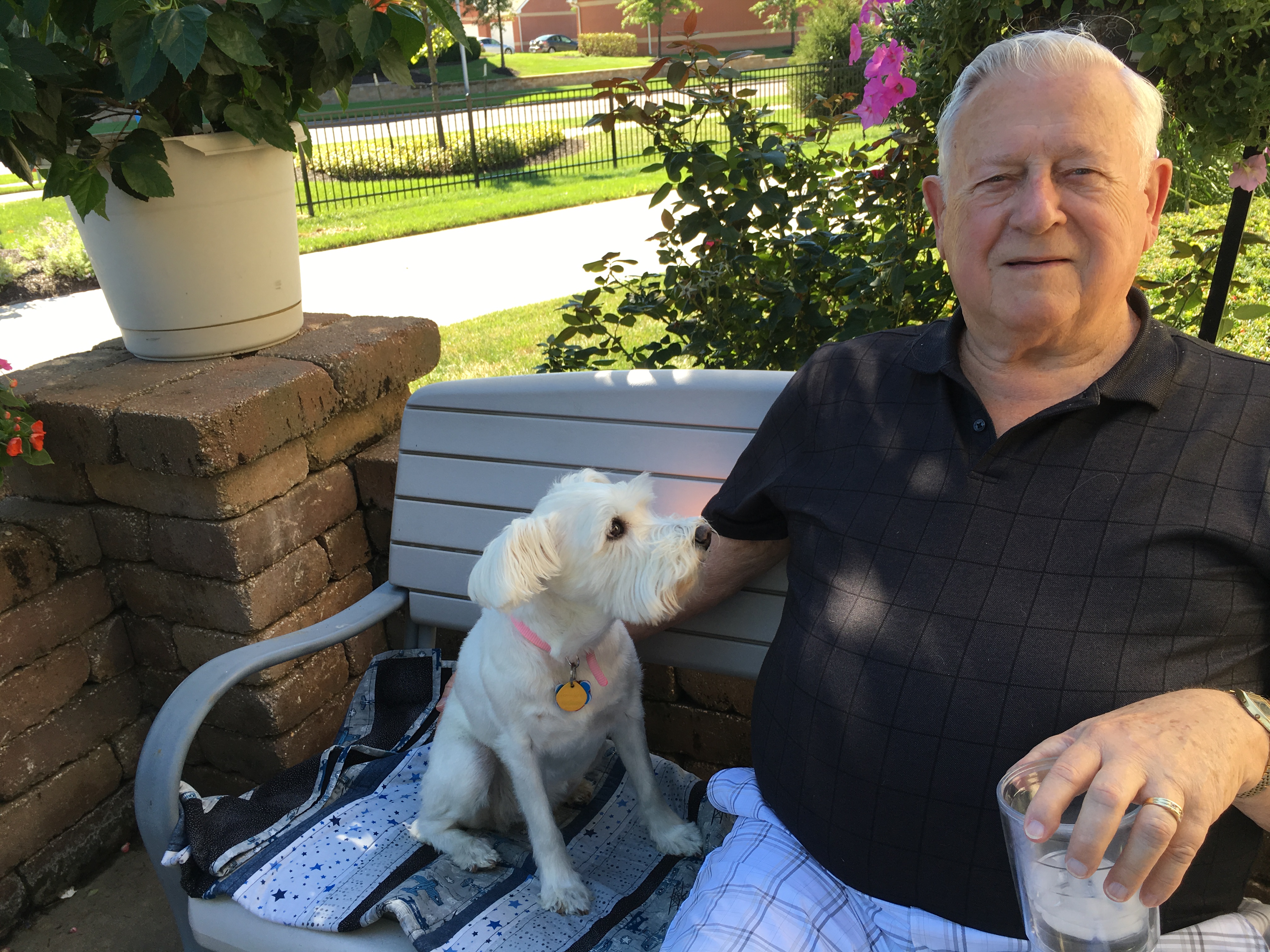 John Blackman sitting outdoors with his dog, showing his approachable and friendly personality